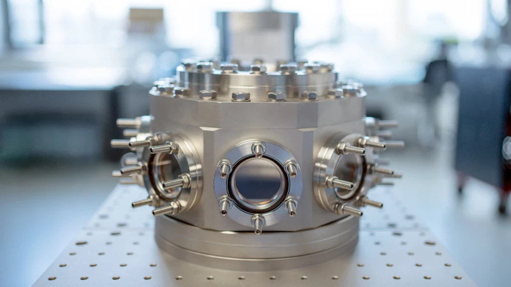The T-Type Optical vacuum chamber mounted on an optical table, with free-beam access ports on three sides