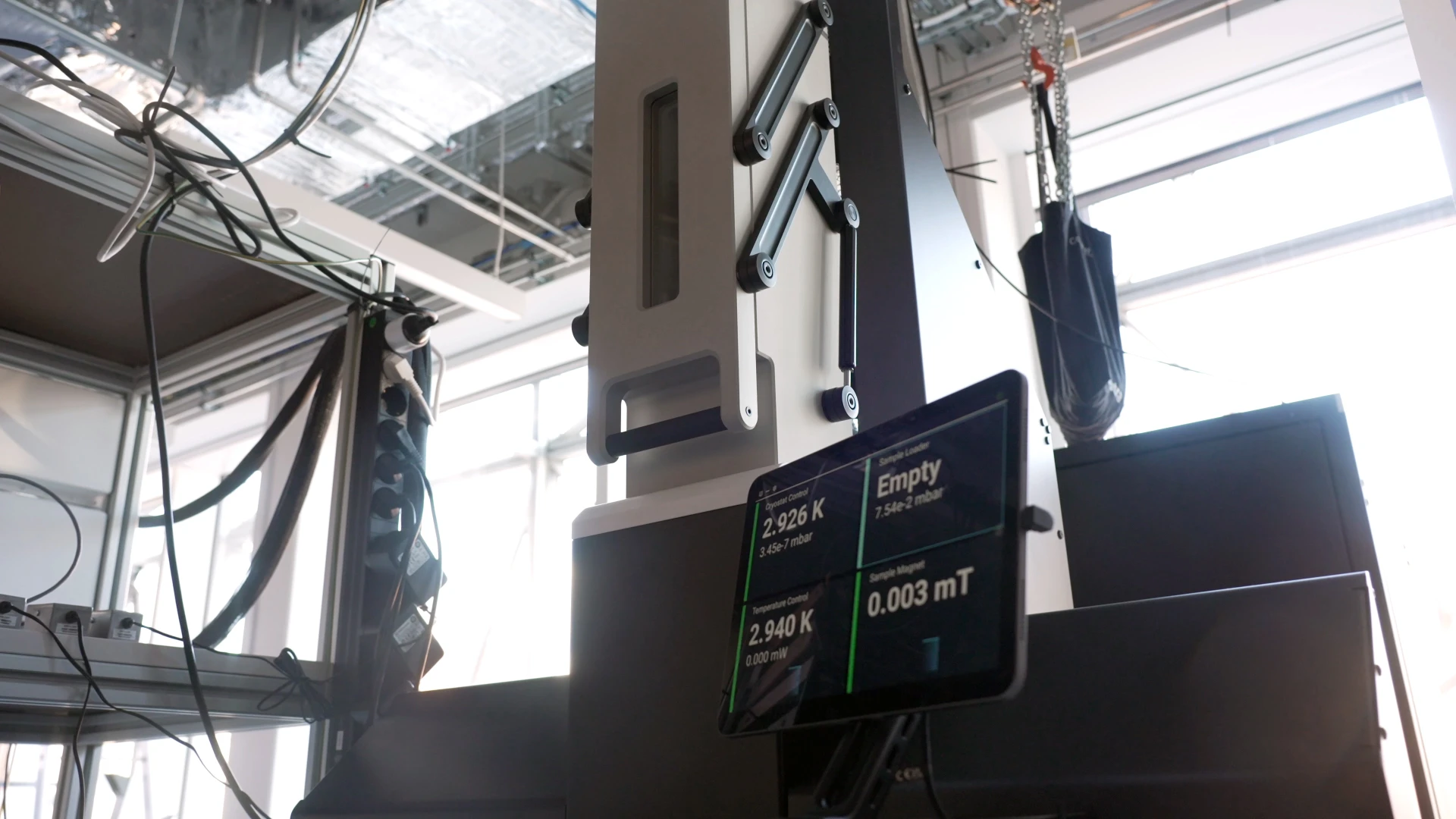 L-Type Rapid seen from below in a lab, its touchscreen showing 2.926 K and an empty sample loader.