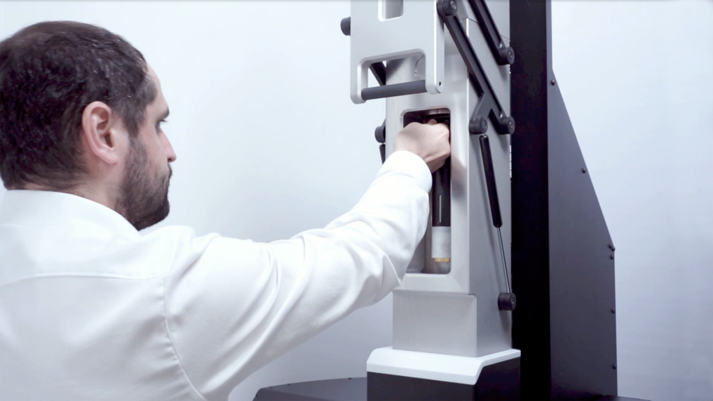 photo of a sample being unloaded from a quantum r&d cryostat