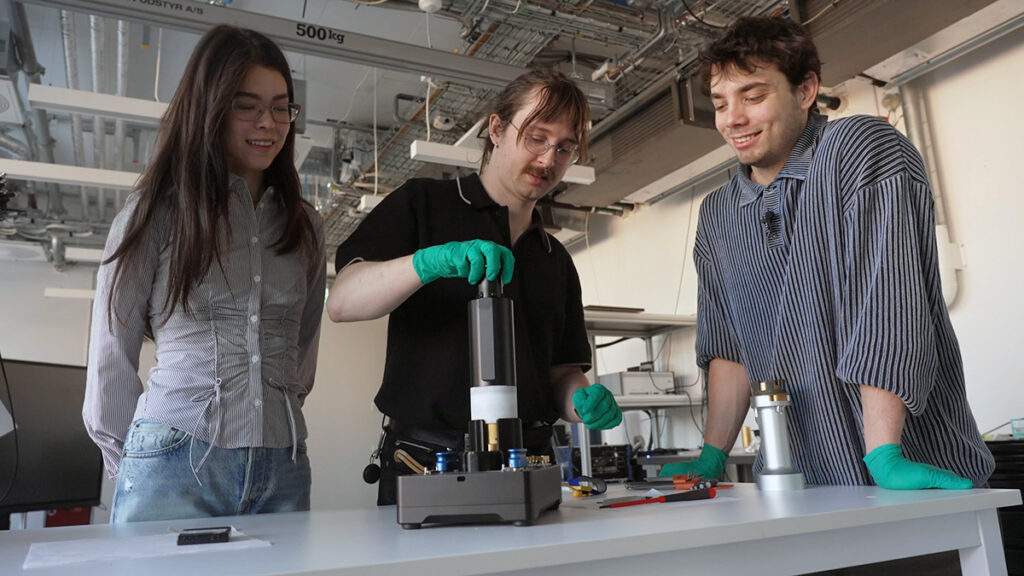 Student picking up sample from the sample station